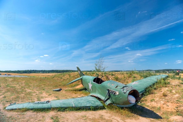 The remains of the crashed military aircraft in the field, stock photo