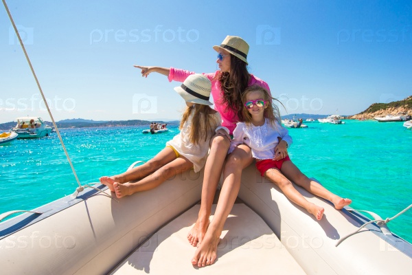 Little girls resting with happy mom on a big boat