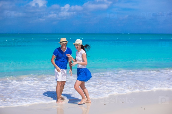 Happy couple have fun on Caribbean beach vacation, stock photo