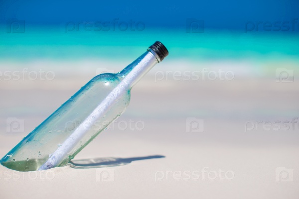 Bottle with a message buried in the white sand