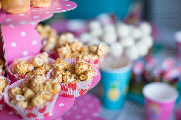 Portion popcorn on kids party on sweet dessert table