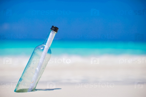 Bottle with a message buried in the white sand