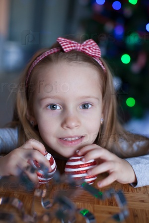 Adorable little girl baking gingerbread cookies for Christmas