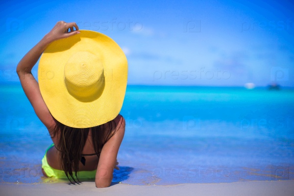 Young woman in yellow hat during caribbean vacation