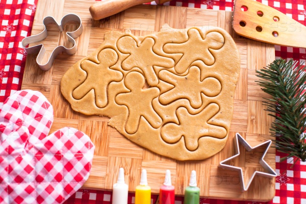 Cutting gingerbread cookie dough for Christmas