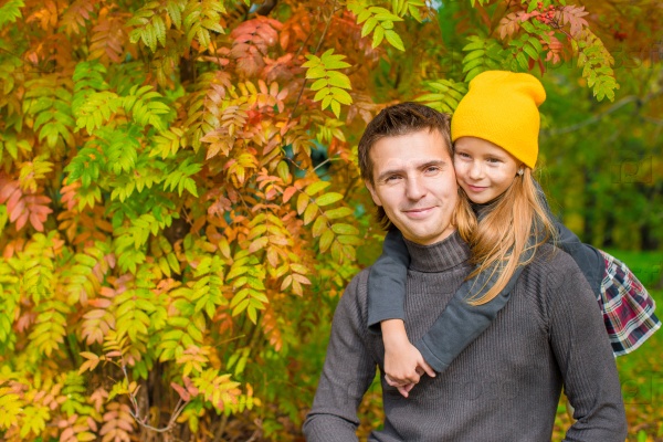 Father with cute daughter in autumn park outdoors