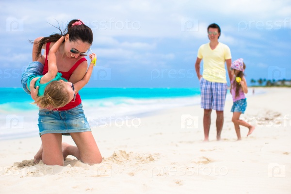 Happy young family vacation on caribbean perfect beach, stock photo
