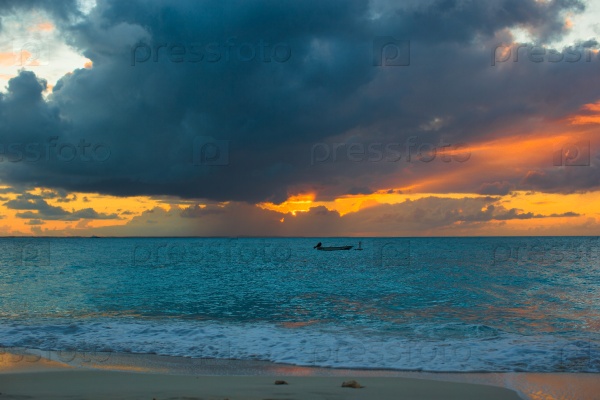 Sailing boat to the sunset in Providenciales island on Turks and Caicos, stock photo