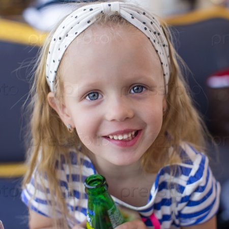 Portrait of little adorable charming girl with bottle water
