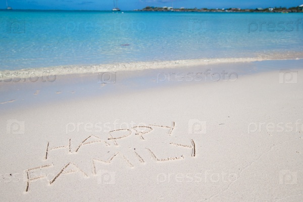 Happy family written on tropical beach white sand