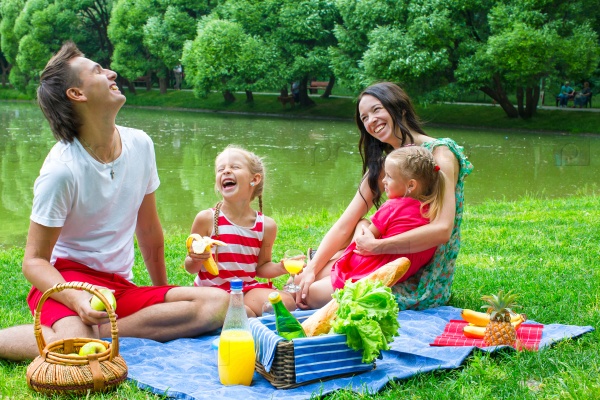 Happy family picnicking in the park and have fun
