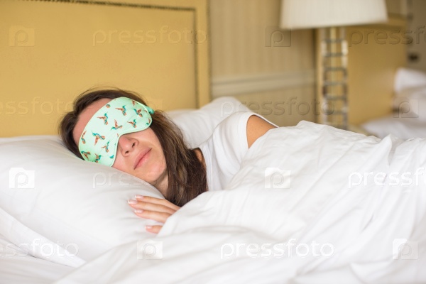 Young attractive woman sleeping in the bed