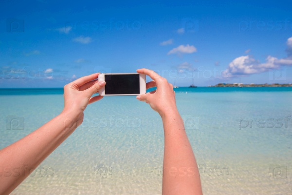Closeup white phone background the turquoise sea, stock photo