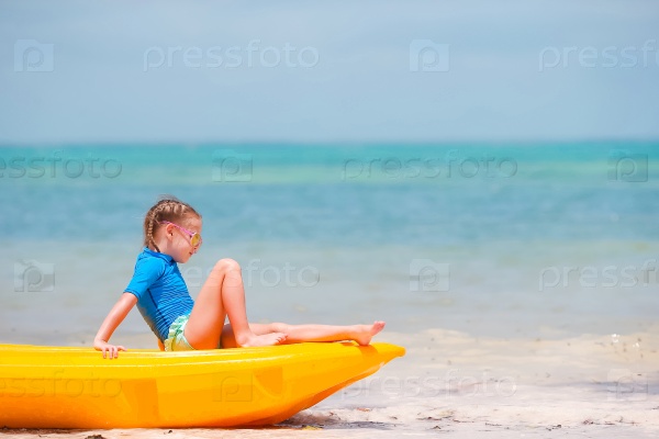 Little girl kayaking during summer vacation in Africa, stock photo