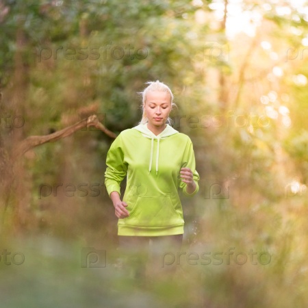 Pretty young girl runner in the forest. Running woman. Female Runner Jogging during Outdoor Workout in a Nature. Beautiful fit Girl. Fitness model outdoors. Weight Loss. Healthy lifestyle. , stock photo