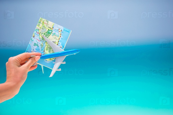 Map and toy airplane background the turquoise sea, stock photo