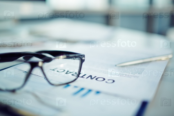 Close-up of a contract and glasses, stock photo