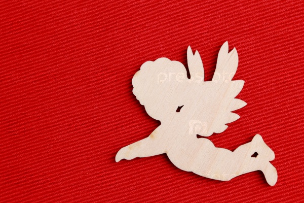 wooden angel silhouette over red background