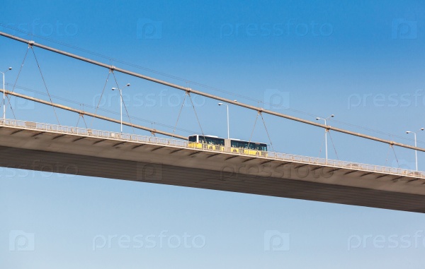 bus on the bridge on Bosphorus connecting the european waterside of Istanbul with the asian waterside on background of blue sky