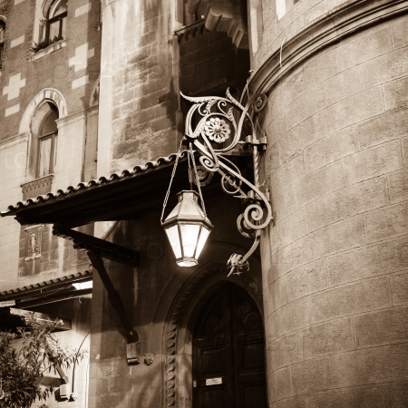 Old forged lantern at night on the background wall with bas relief in Istanbul, Turkey