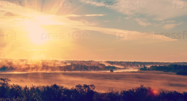 sunrise with the mist over the river and the forest in central Russia in the summer