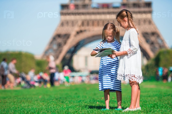Adorable little girls in Paris background the Eiffel tower in France, stock photo