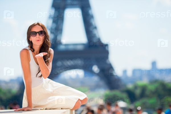 Adorable woman in Paris background the Eiffel tower in France, stock photo