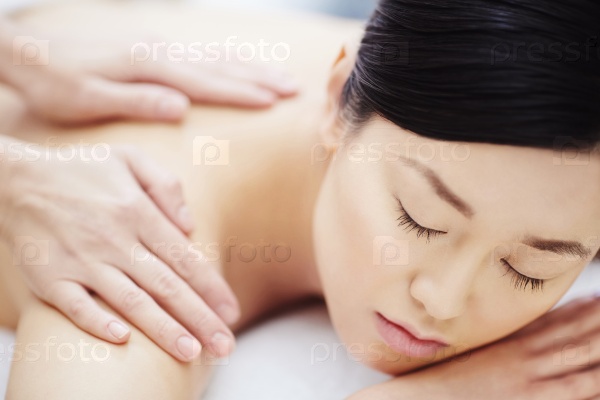 Pretty girl enjoying massage, stock photo