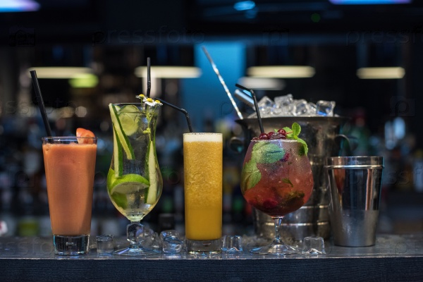 Glasses of different cocktails on bar background, stock photo