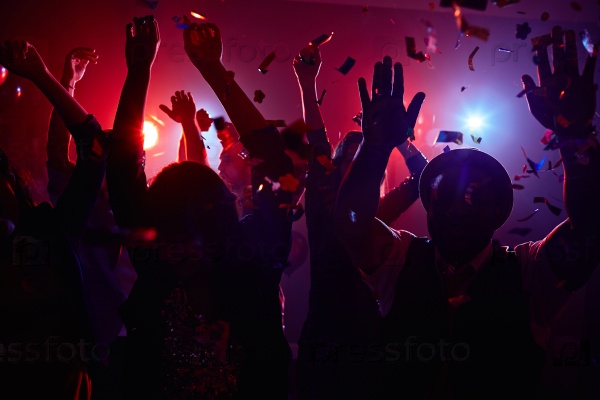 Modern young people dancing at disco in night club, stock photo
