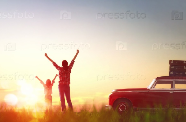 Toward adventure! Happy family relaxing and enjoying road trip. Beautiful young mother and her child girl rejoice in the dawn, stock photo