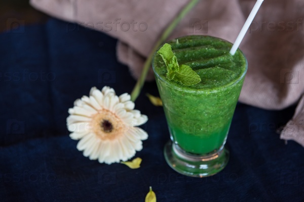 Healthy organic green smoothie with basil mint and lemon, stock photo