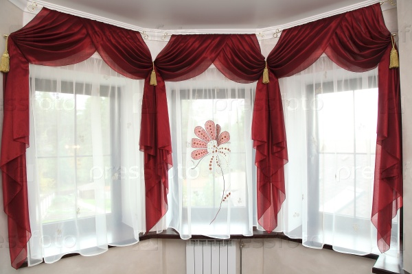 richly decorated curtain at windows in the room
