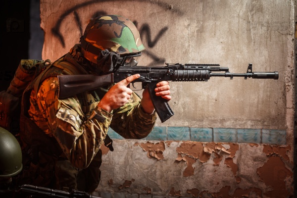 Soldier with the russian machine gun in abandoned building, hero shot, stock photo