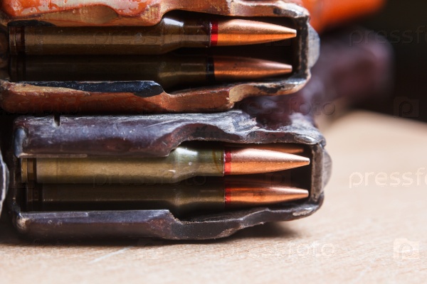 7.62 ammo for machine guns with loaded magazines on table, stock photo
