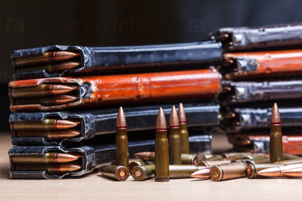 7.62 ammo for machine guns with loaded magazines on table, stock photo