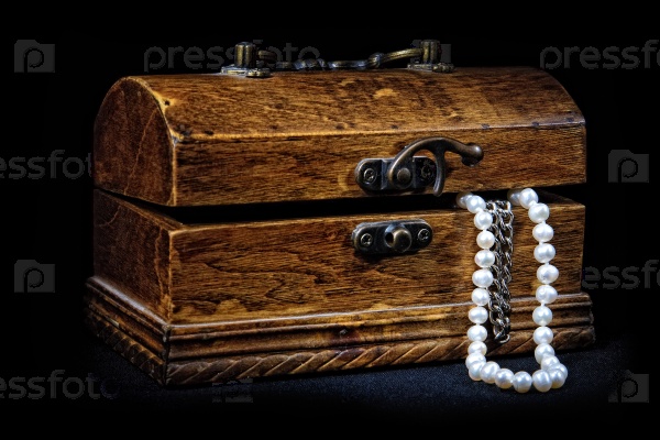 Chest with treasures isolated on black