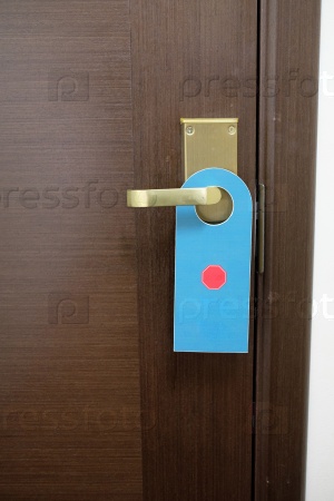 image of a Do not disturb sign hang on door knob