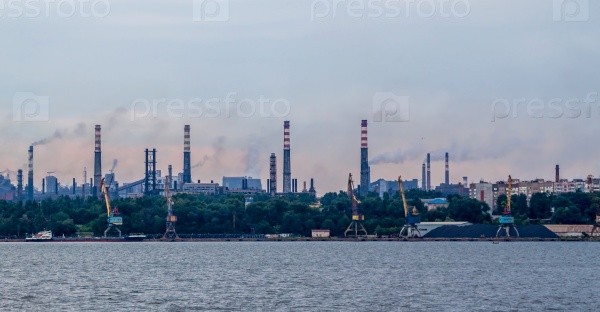Industrial landscape with factory pipes and smoke going out, stock photo