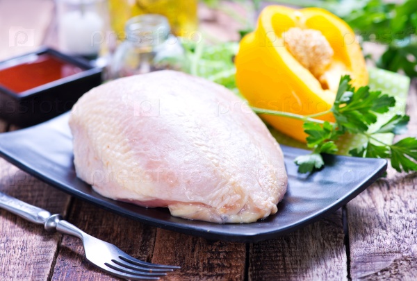 Chicken fillet on plate and on a table, stock photo