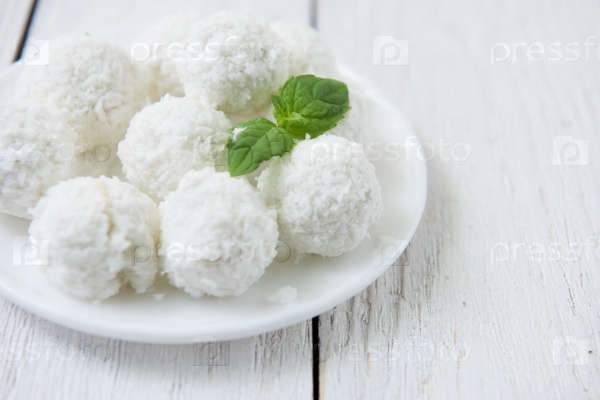 Homemade coconut candies with filling of cream and nut, stock photo