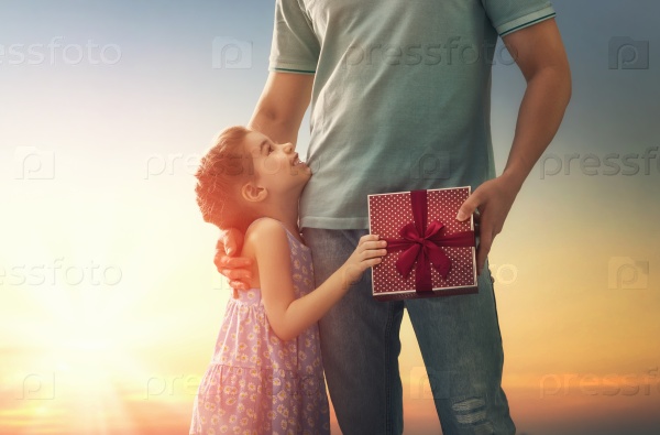 Happy loving family and Father\'s Day. Father and his daughter. Cute child girl gives a gift to dad.