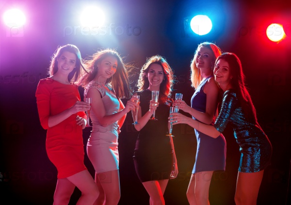 Party, holidays, celebration, nightlife and people concept - smiling young beautiful girls dancing in club, stock photo
