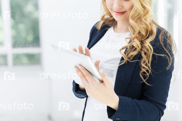 The smiling female office workers with laptop in office, stock photo