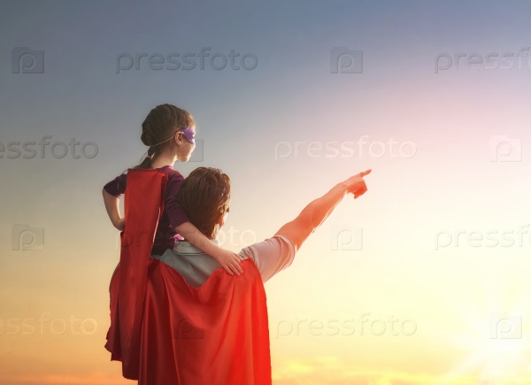 Happy loving family. Father and his daughter child girl playing outdoors. Daddy and his child girl in an Superhero\'s costumes. Concept of Father\'s day.