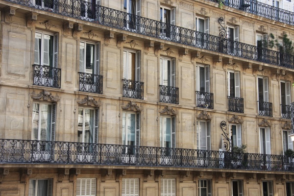 View of the walls of the house with Windows and French balconies in Paris