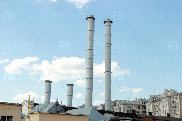 Old factory chimneys against the blue sky