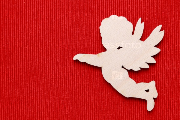 wooden angel silhouette over red background
