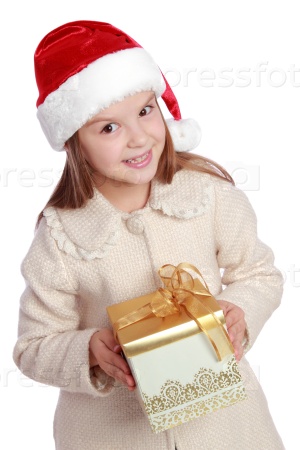 Studio portrait of a happy surprised little girl with long hair in red Santa hat holding a present isolated on white/Image of lovely child in a Santa hat with Christmas present