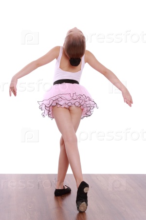 little ballerina in a pink tutu standing back to camera